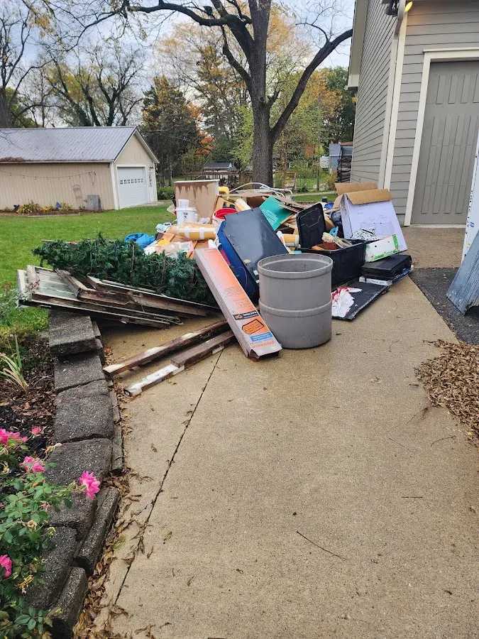 Dumpster being loaded with debris for Estate Cleanout Dumpster Rental in Higginsville